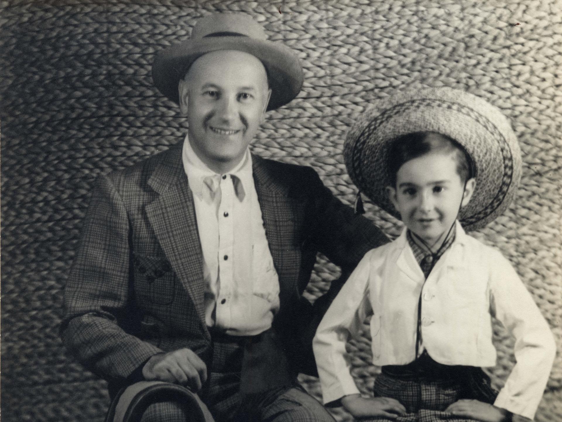 Fotografía en blanco y negro en que aparece padre e hijo vestidos con traje de huaso.